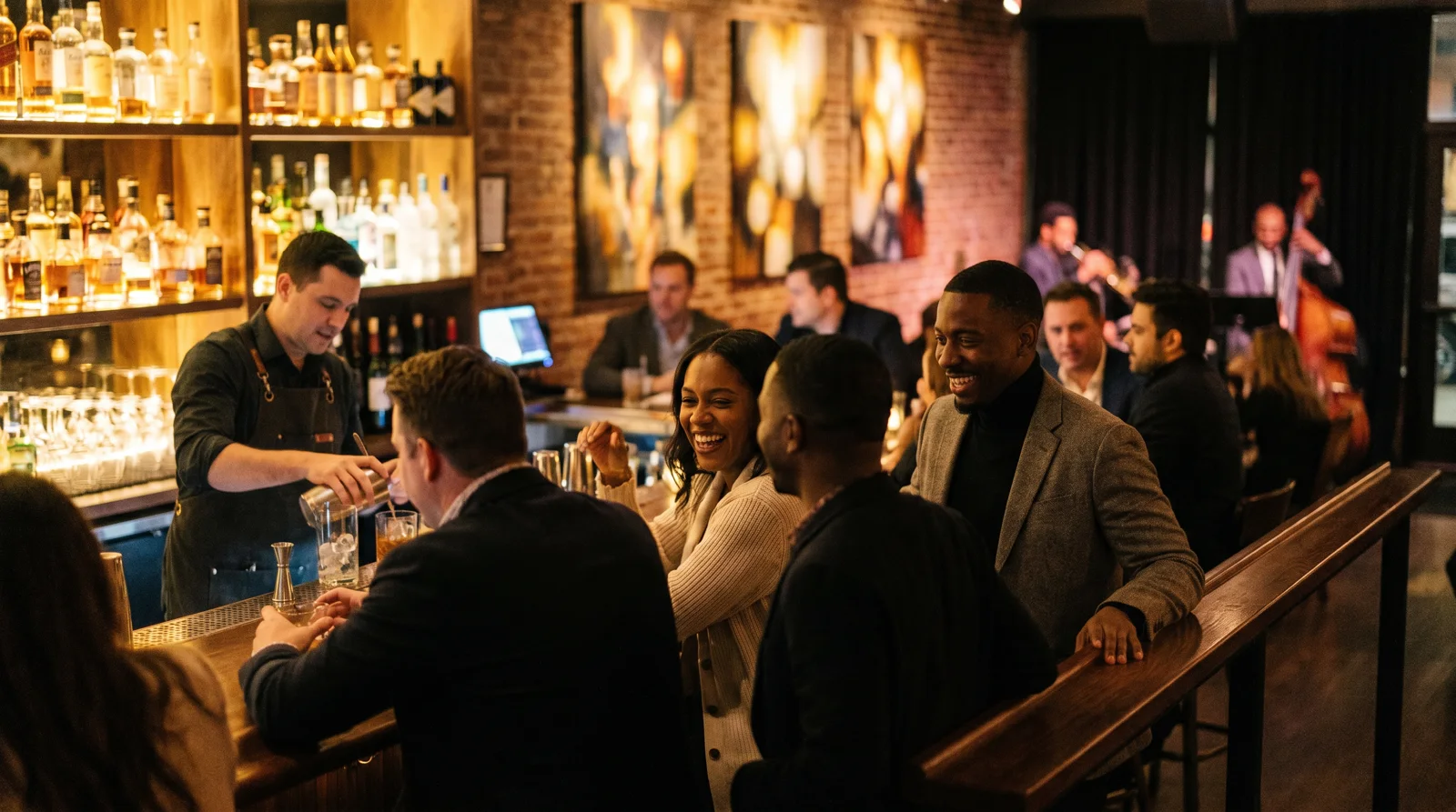 People chatting at the bar rail of a stylish martini lounge at night